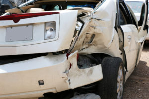 front bumper and hood of white car smashed in