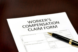 workers compensation claims form with a pen