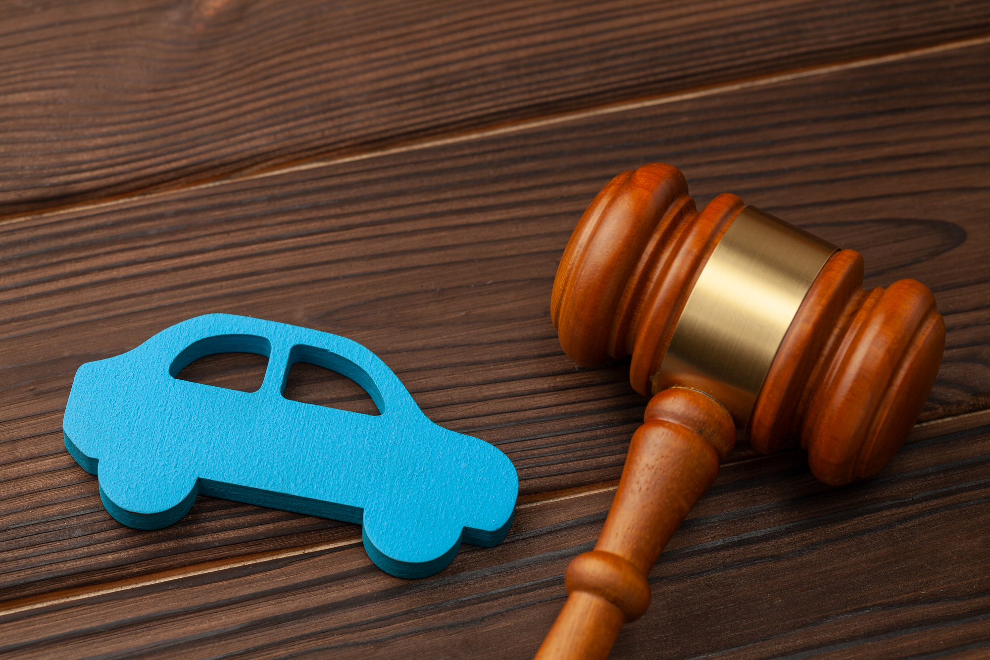 Car Accident Lawyer Lake County, IL - Selling or buying a car at auction. The verdict on a car accident, court. Blue car and judge gavel