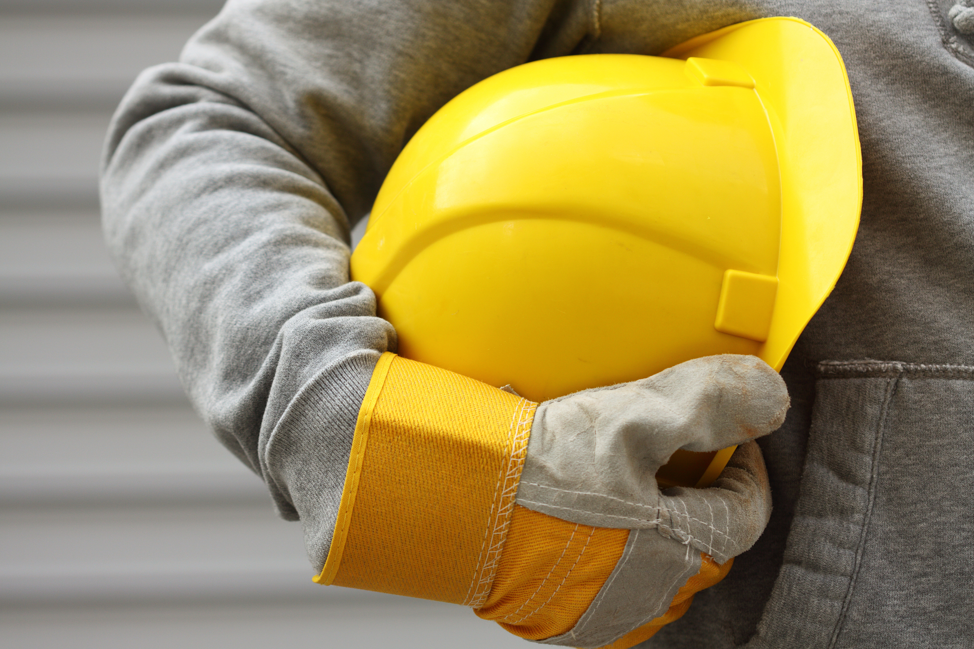 Workers' Compensation Lawyer Lake County, IL - Man holding yellow helmet close up